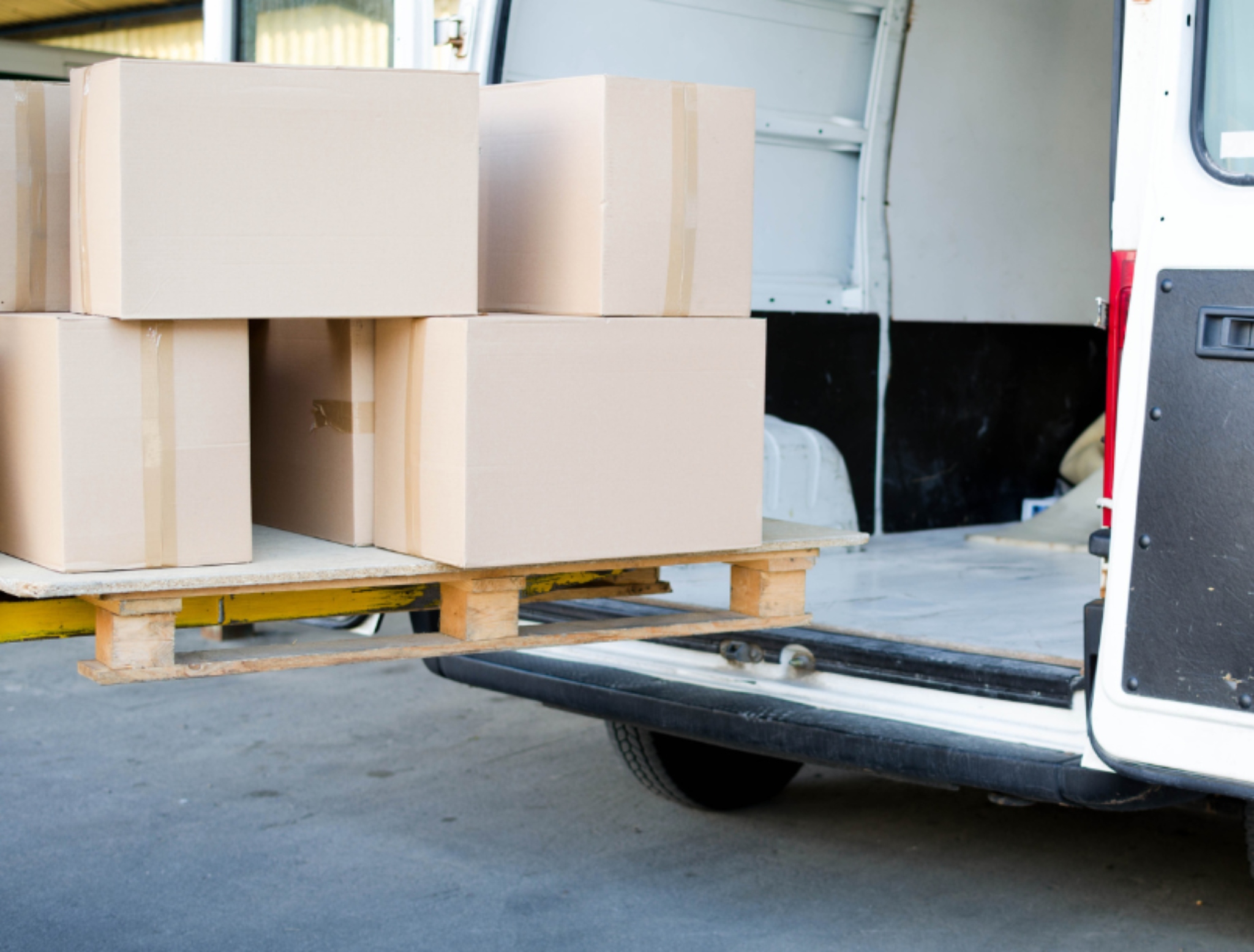 courier putting goods into van